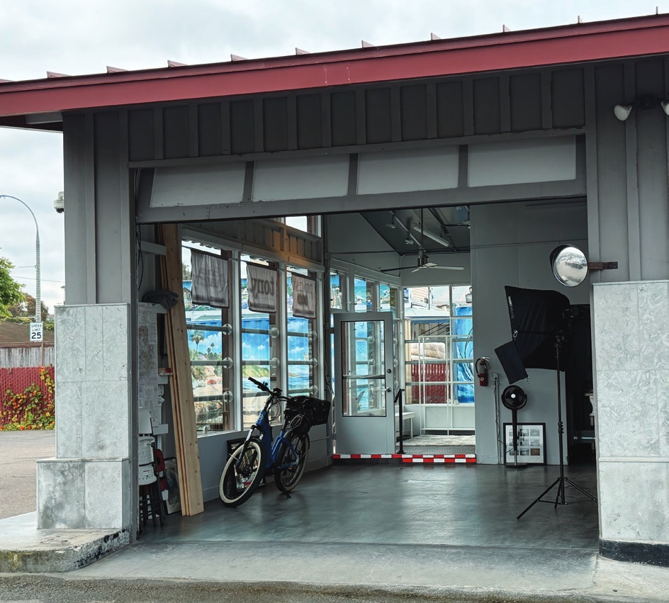 The studio with its garage door open — lighting, bikes and workspace visible